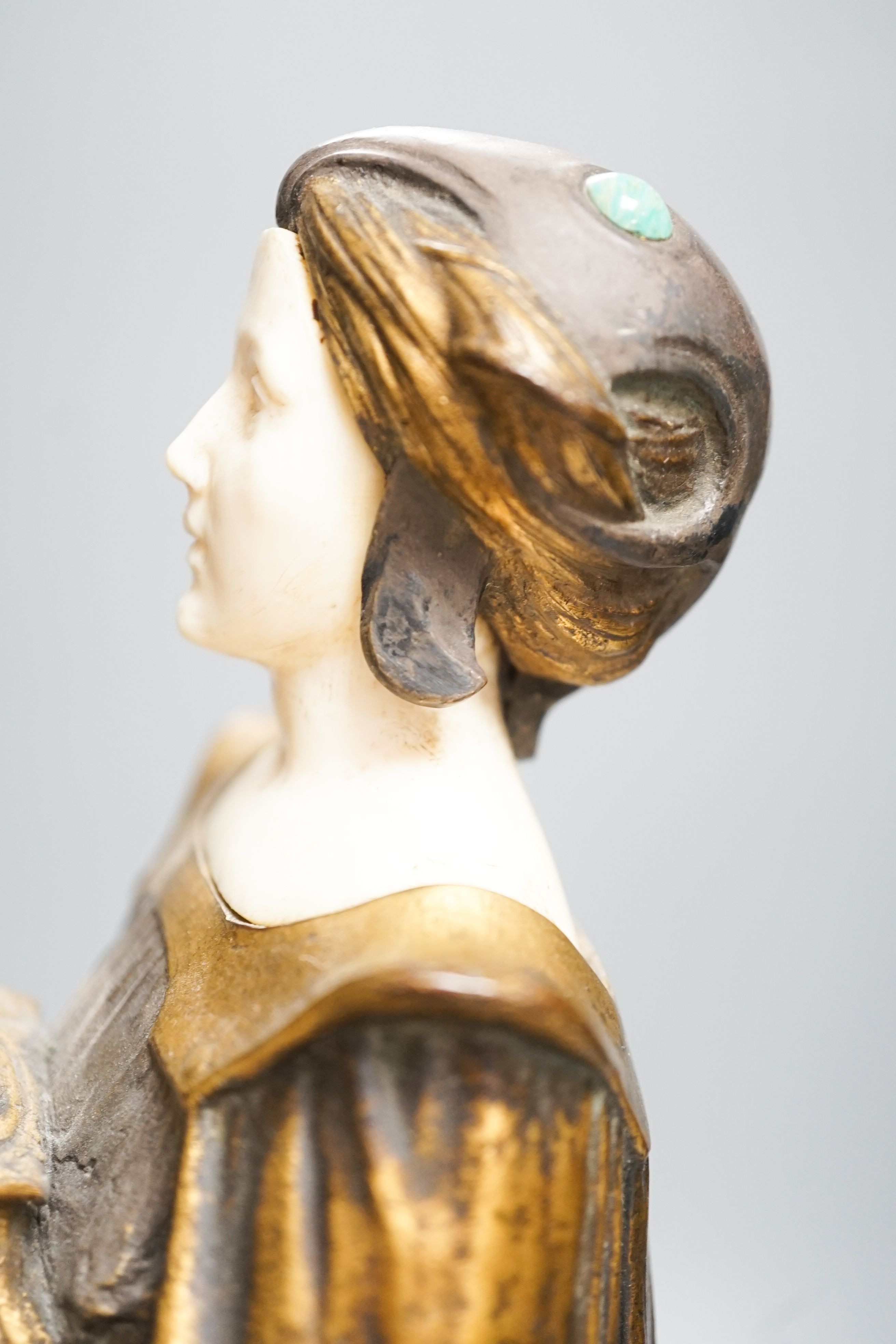 A German Art Nouveau bronze and ivory figure of Pandora, with inset carved ivory head and hands on polished stone and cut wood base, signed F. Jahn, 41cm high